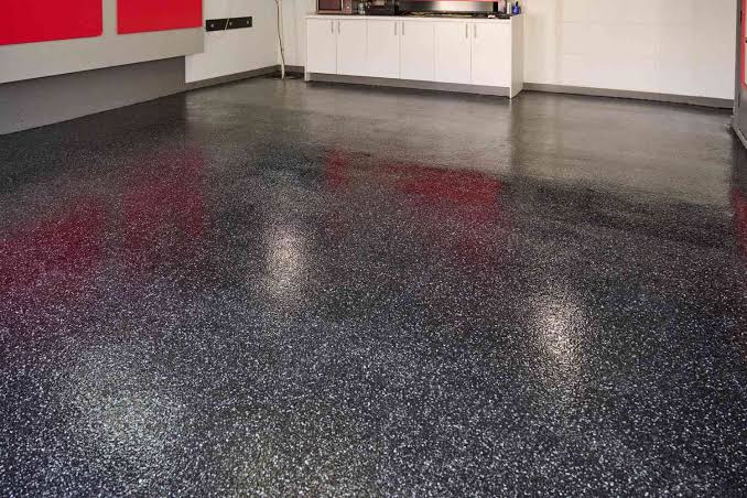 Close-up of a dark flake epoxy floor coating surface